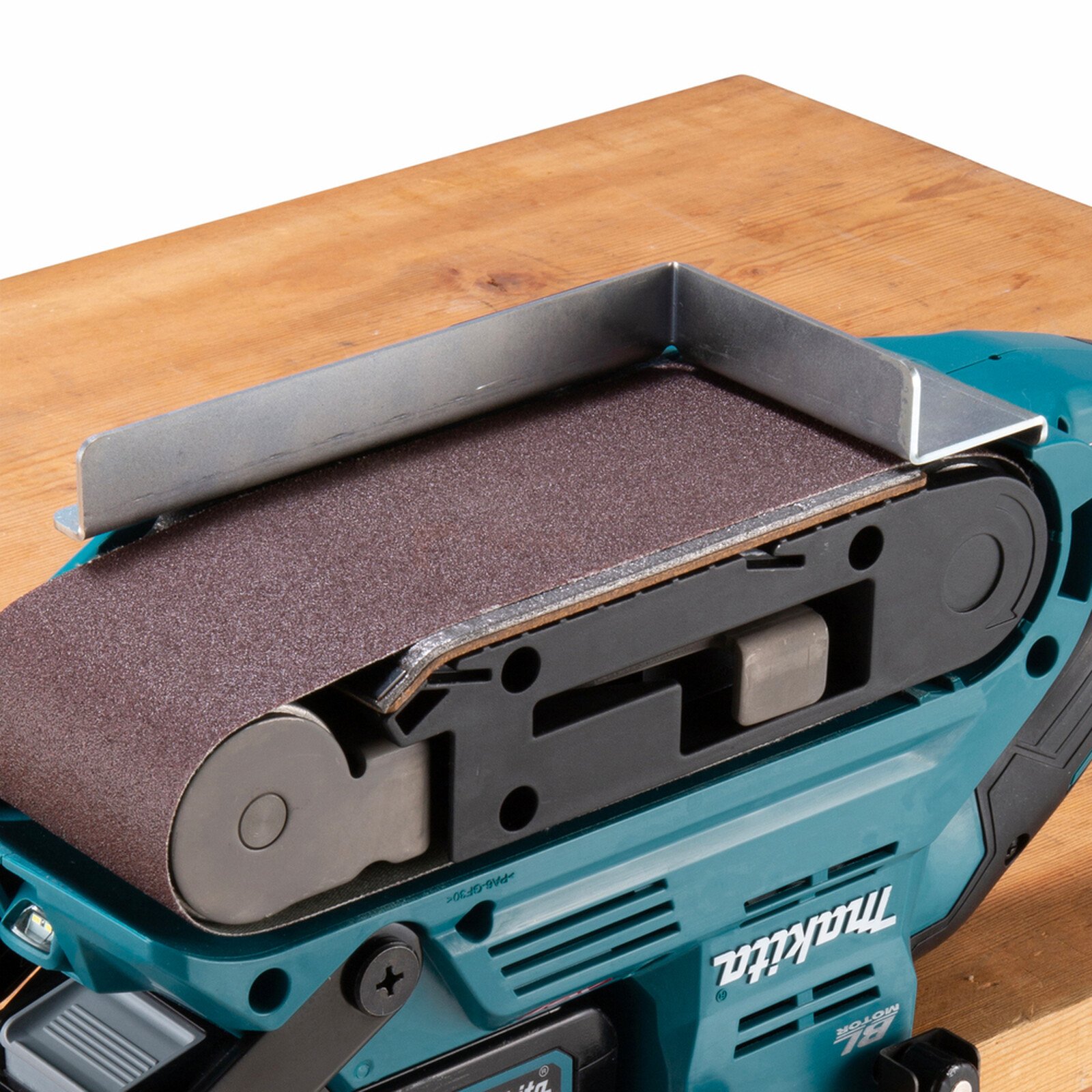 Pildil on Makita tagurpidi töötamise rakis, mis on kinnitatud lihvijale, näidates selle kasutamist detailide lihvimiseks.