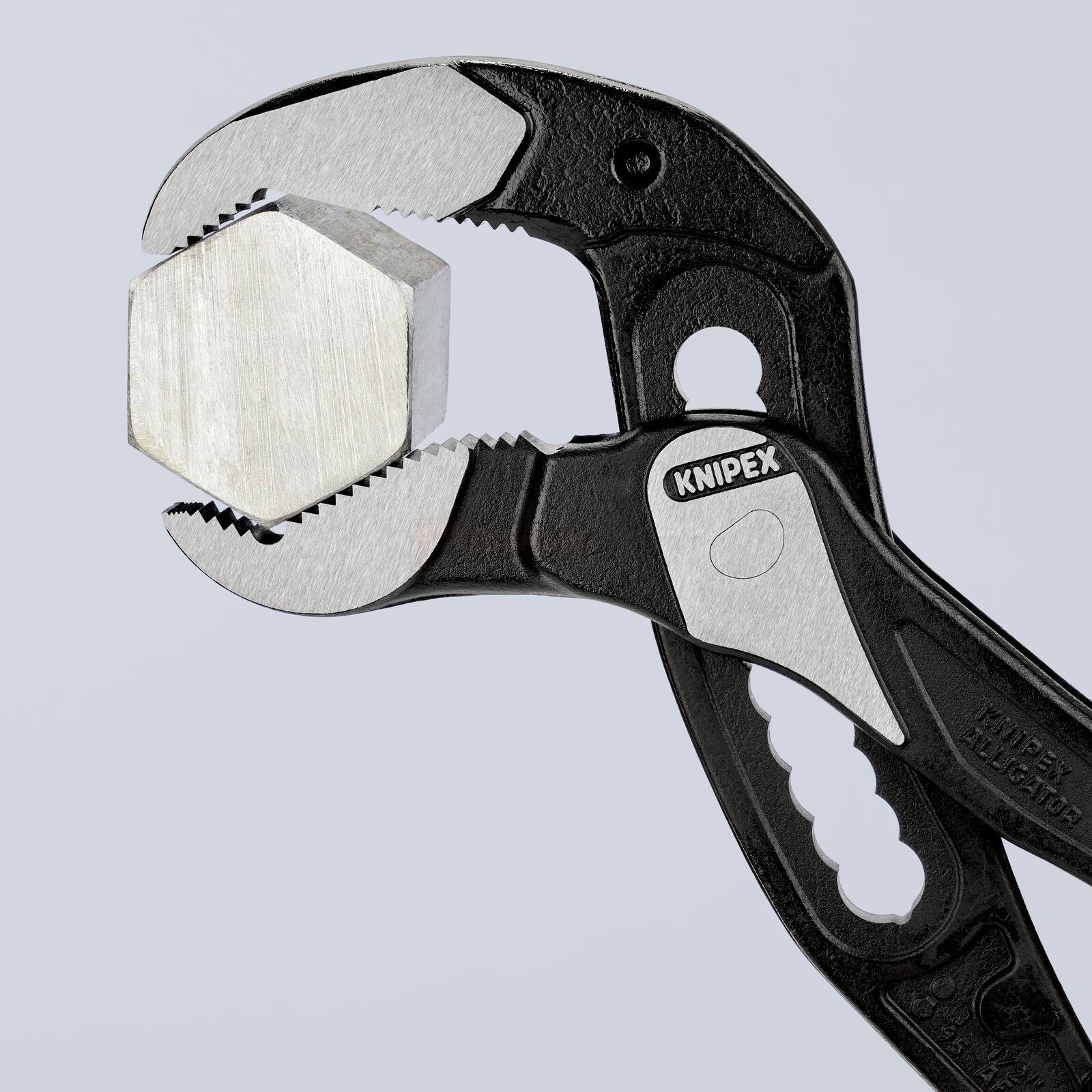 Pildil on Knipex Alligator® XL toruvõti ja veepumba tangid, mis hoiavad kinni kuuskantpeaga polti.