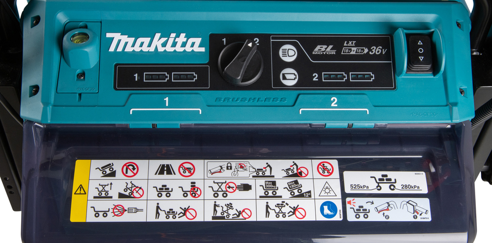 Pildil on Makita akutoitega tõstuk-käru DCU601Z, millel on juhtpaneel, akulaadimise näidikud ja ohutusnõuete kleebised.