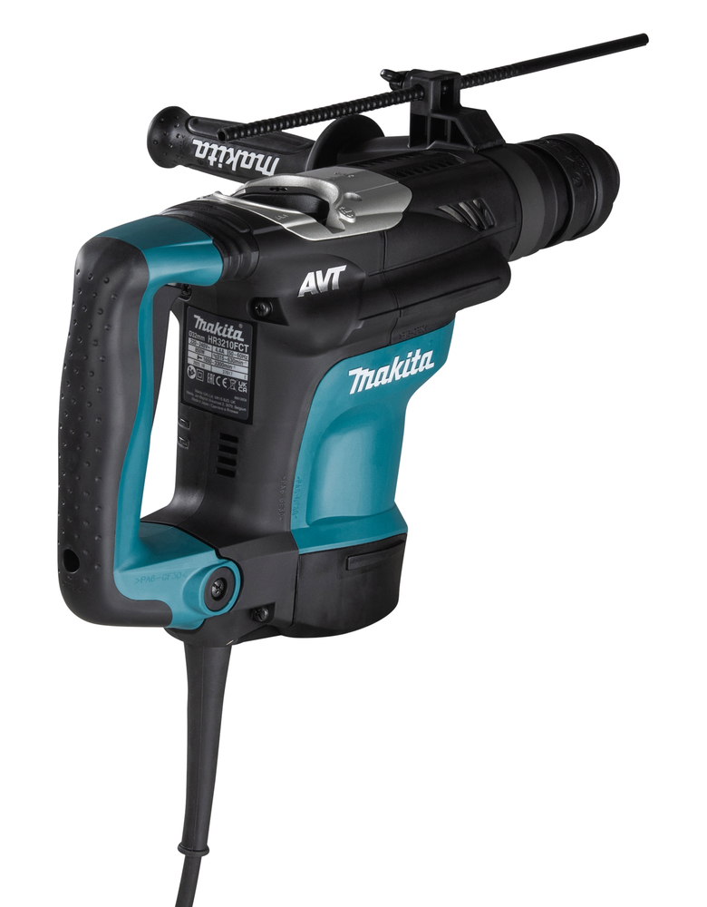 Pildil on Makita puurvasar HR3210FCT, millel on roheline ja must värv, lisakäepide ning toitejuhe.
