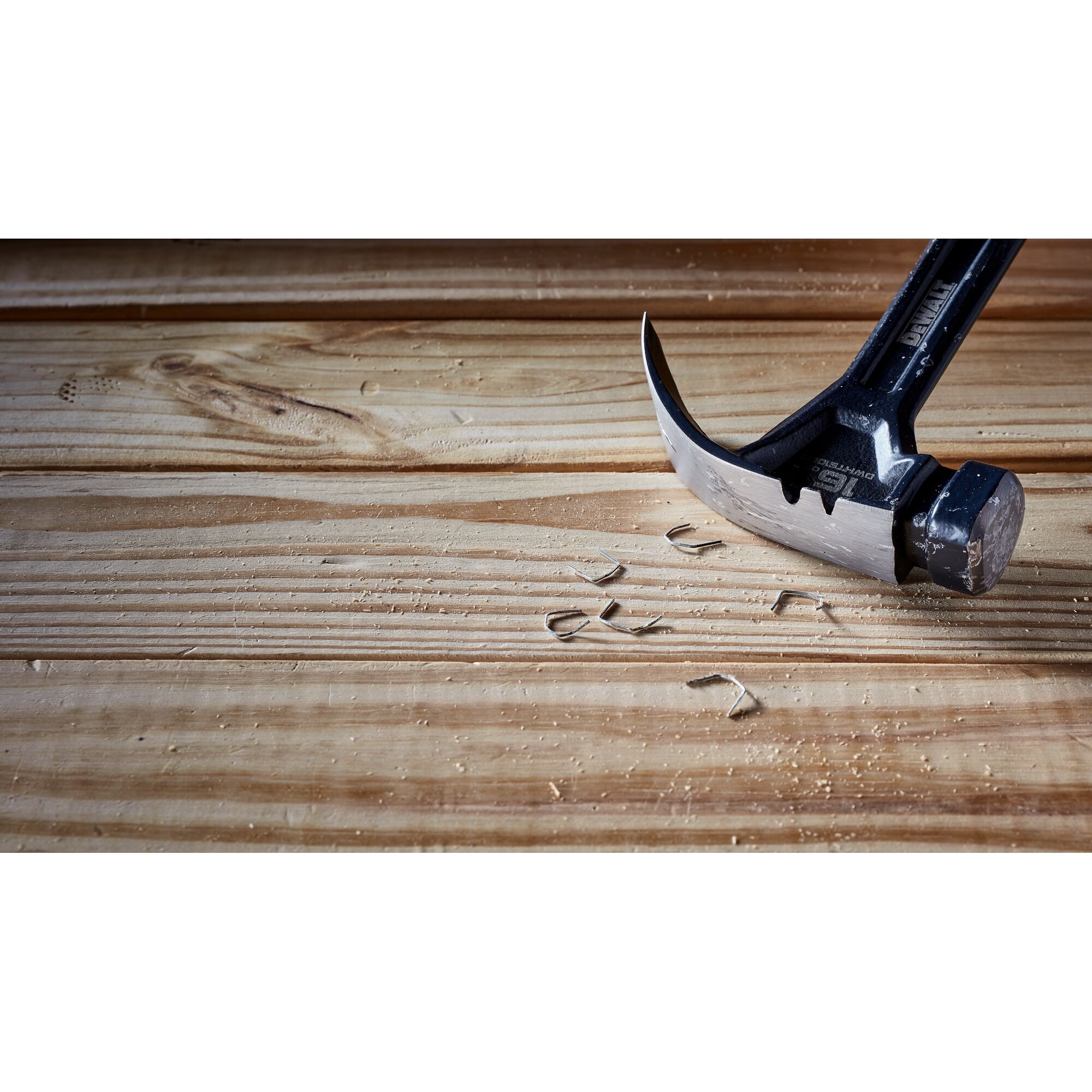 Pildil on DeWalt sõrgvasar DWHT51002-0 454 g, mis on asetatud puidule ja ümber on laiali klambrid.