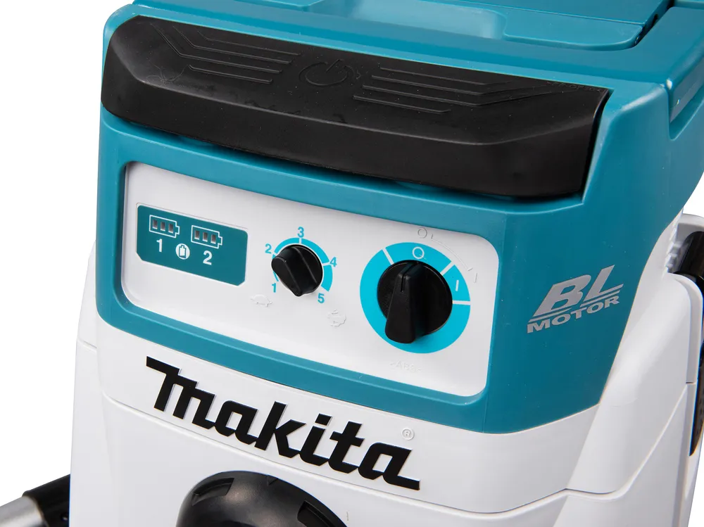 Pildil on Makita akutolmuimeja DVC156LZX1 detail, millel on juhtpaneel aku taseme näidikute, lülitite ja mootori logoga.