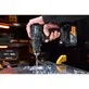 Pildil on käes Dewalt akulööktrell DCD86MP2T McLaren F1 Team Special Edition, millega puuritakse auke metallplaati.