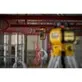 Pildil on näha DeWalt pöördlaser DCLE05211R, mis on paigaldatud torustikule tööstuslikus keskkonnas.
