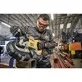 Pildil on mees, kes kasutab DeWalt akutoitel lintsaagi 18V XR DCS374N, et lõigata metalltoru.