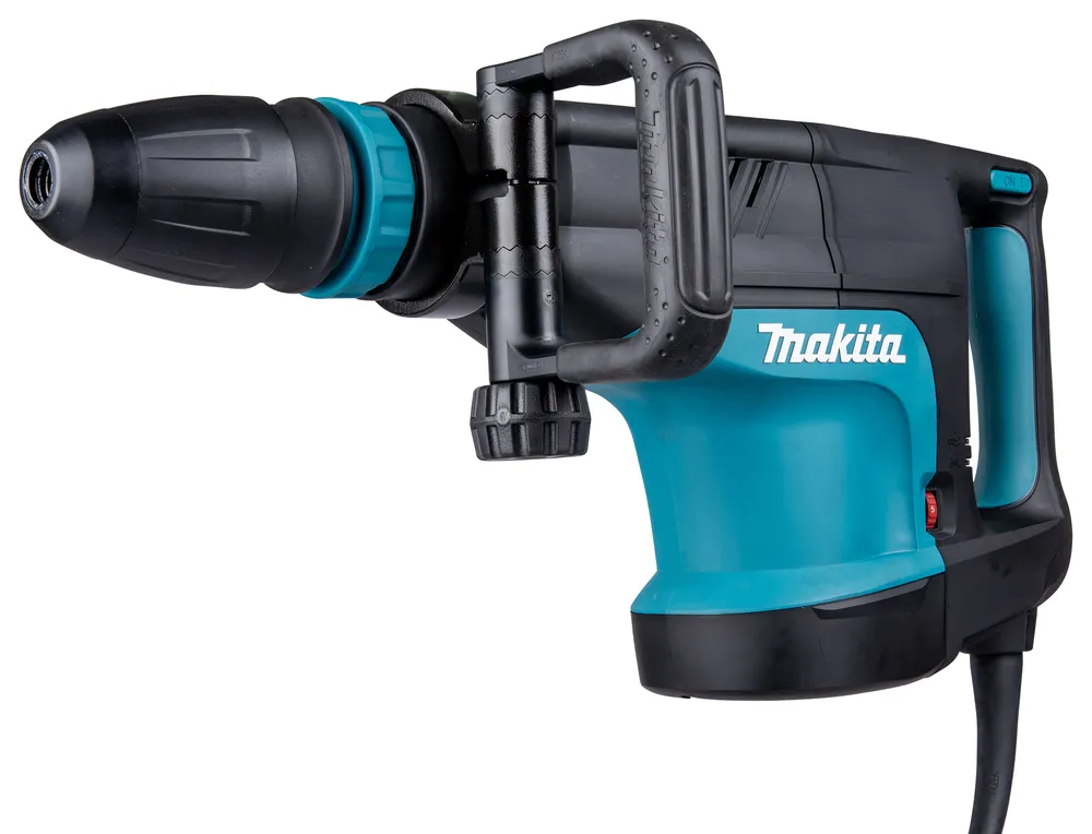 Pildil on Makita piikvasar HM1203C, millel on sinine korpus ja mustad detailid, ning mida on näha valgel taustal küljelt.