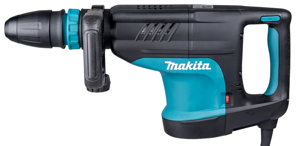 Pildil on sinimust Makita HM1203C piikvasar, millel on küljel lüliti ja peal "ON" nupp.