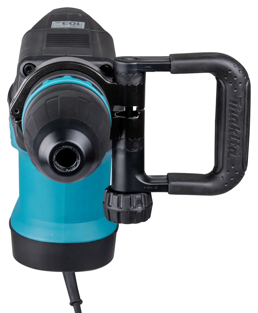Pildil on Makita piikvasar HM1203C, millel on silmapaistev sinine korpus, must käepide ja reguleeritav küljekäepide.