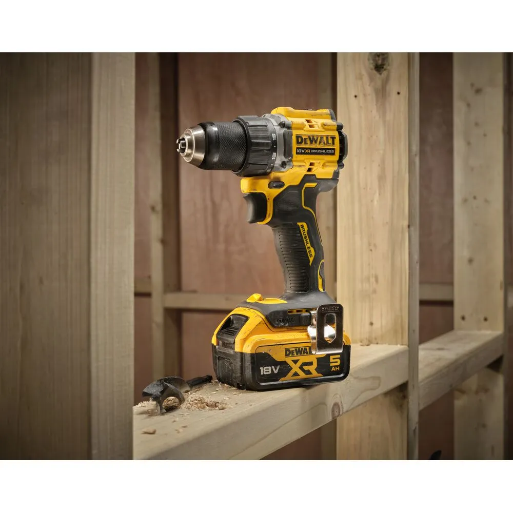 Pildil on Dewalt 18V XR Brushless akupuurvasara, mis on paigutatud puitkonstruktsioonile koos puuriterade ja laastudega.