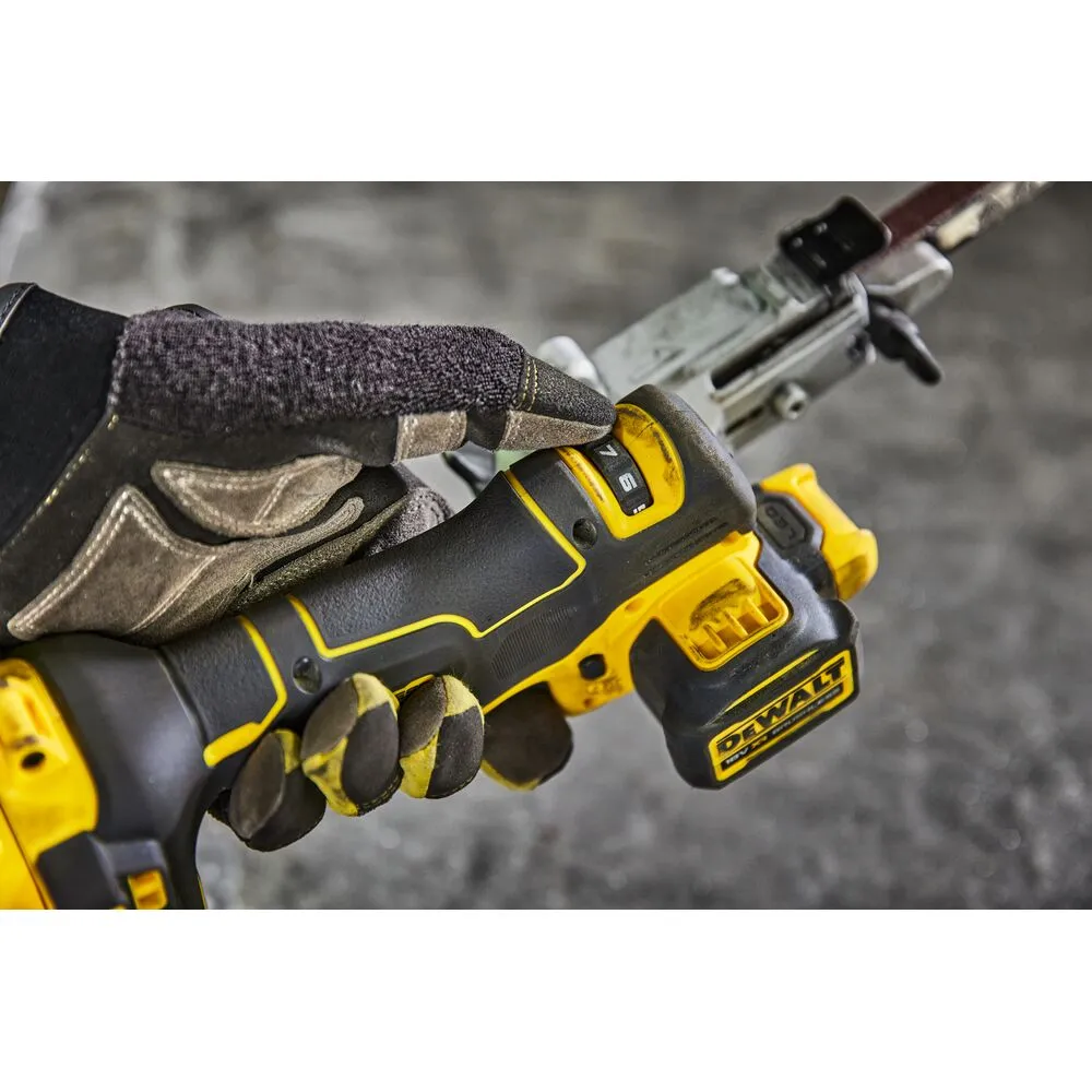 Pildil on DeWalt akulintlihvija DCM200E2T, mida hoitakse kinnastega käes, ja näha on lihvimislindi pealispinda.